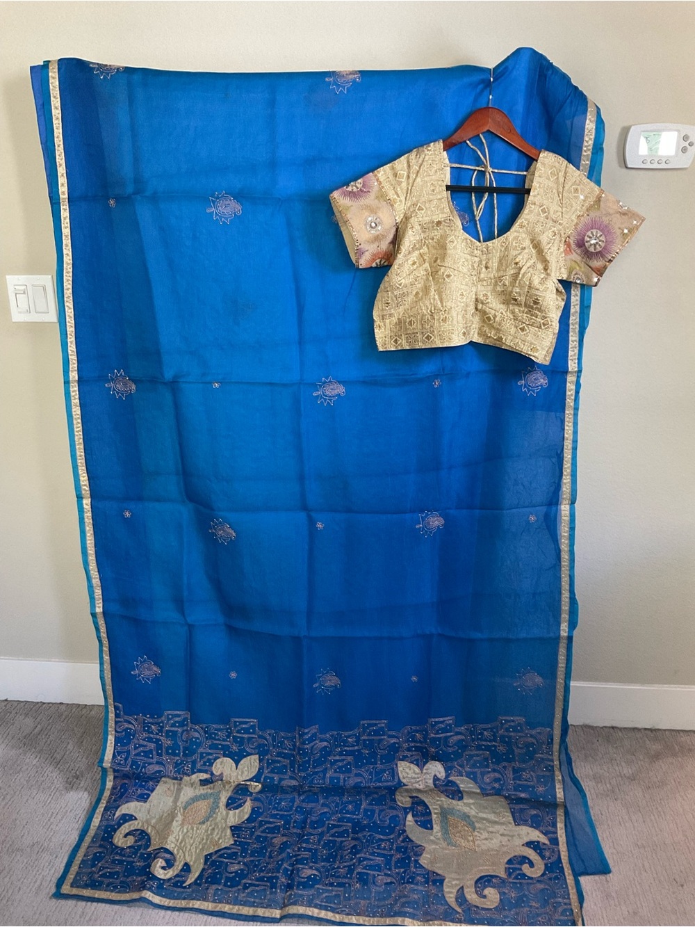 Vibrant Blue Organza Saree with Gold Embroidered Blouse